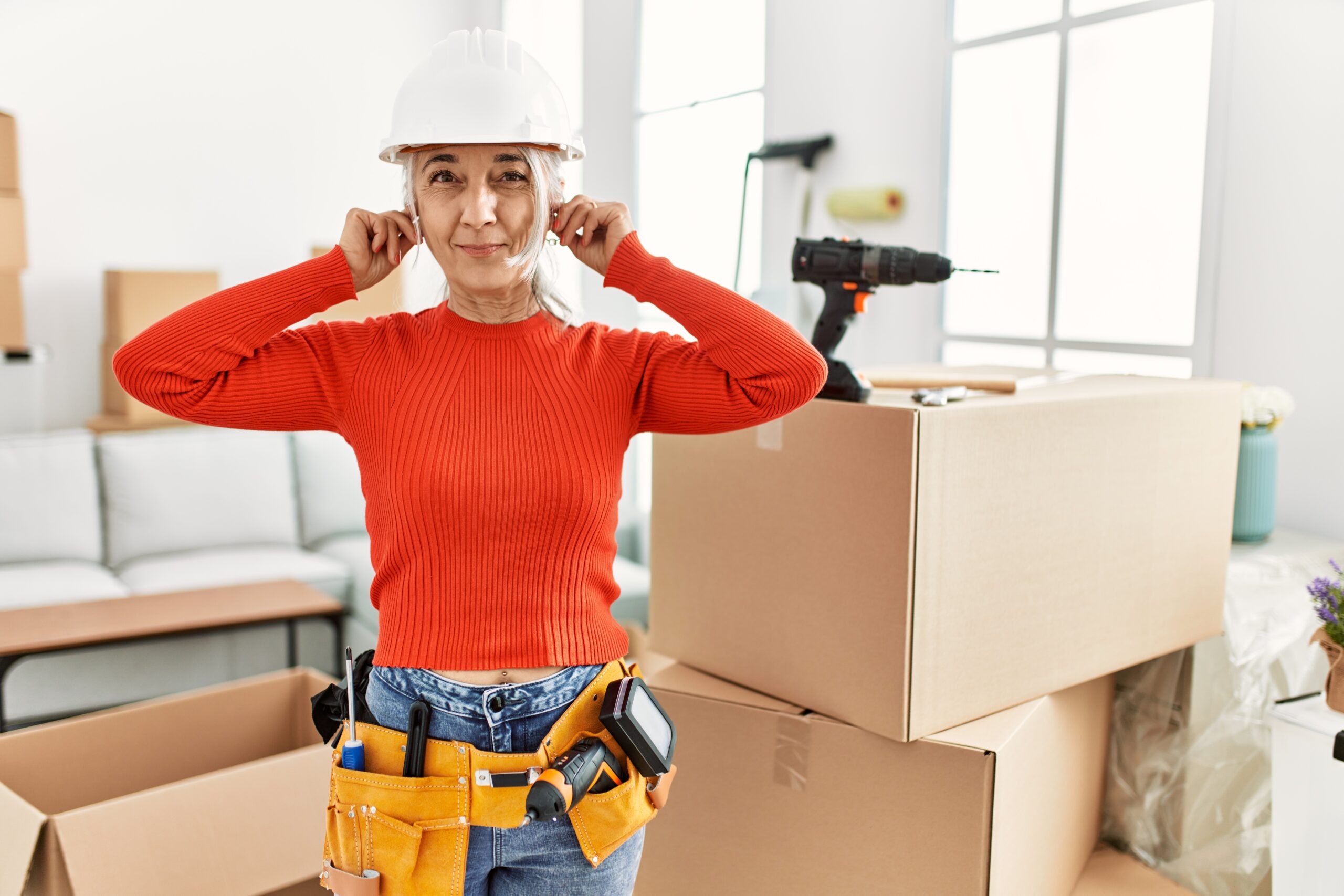Middle,Age,Grey-haired,Woman,Wearing,Hardhat,Standing,At,New,Home